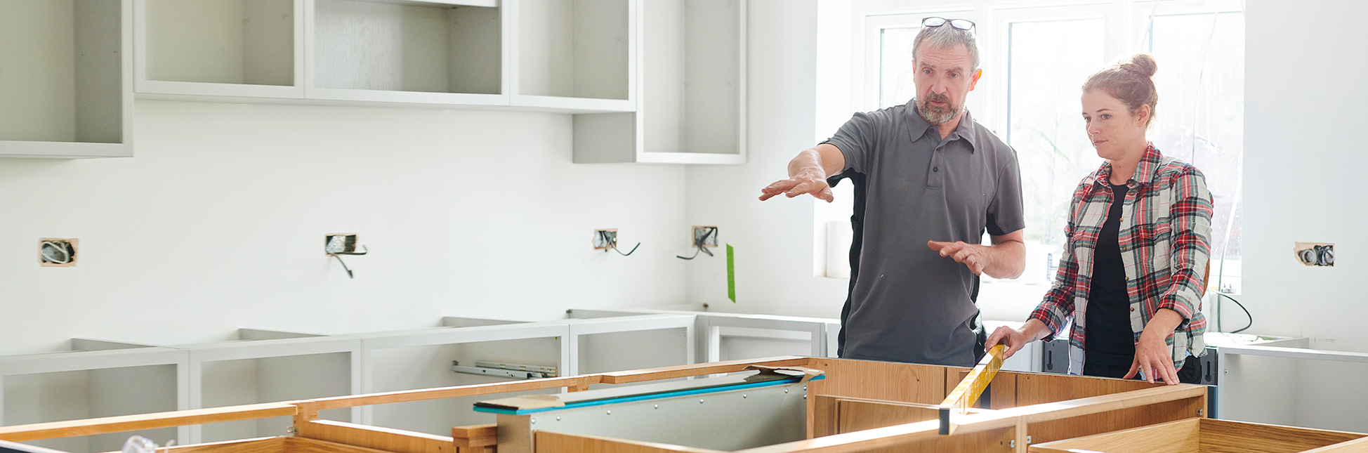 two people working on kitchen modification