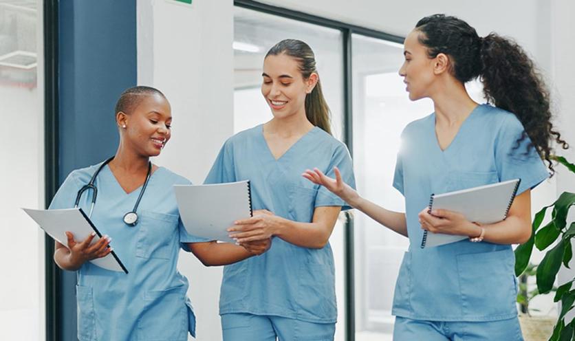 Nurses walking down hallway in hospital